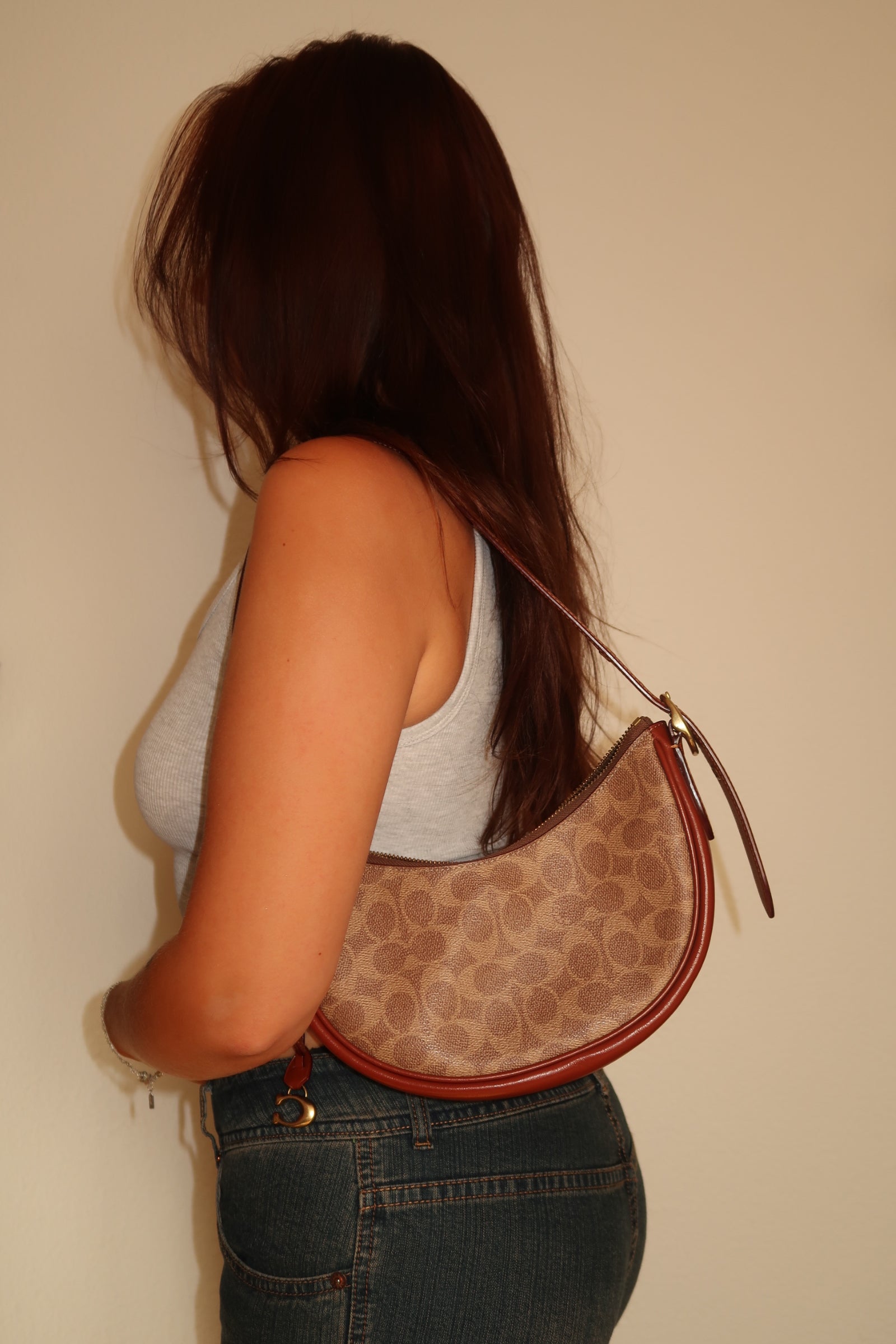 wearing Vintage Coach leather shoulder bag in brown.
