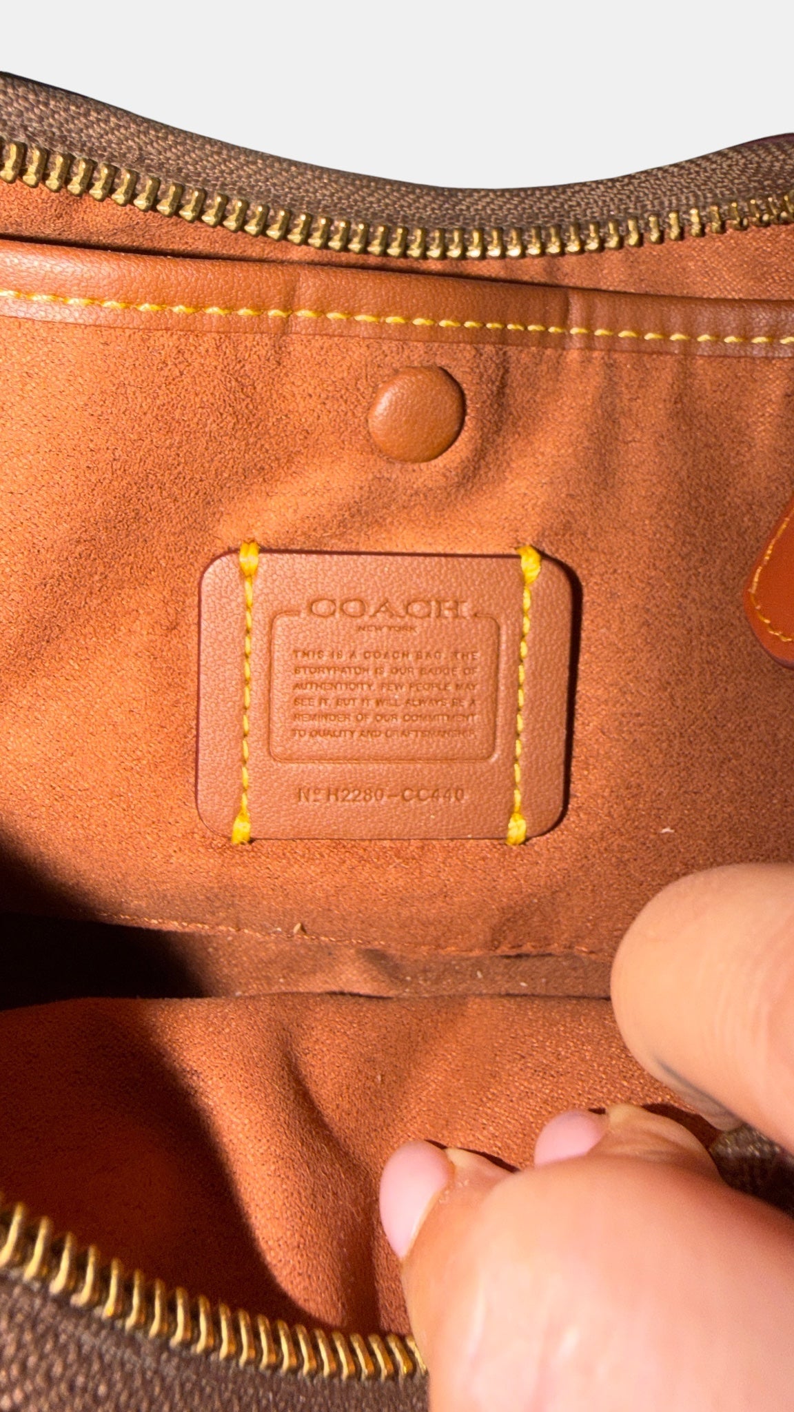 Logo inside Vintage Coach leather shoulder bag in brown.
